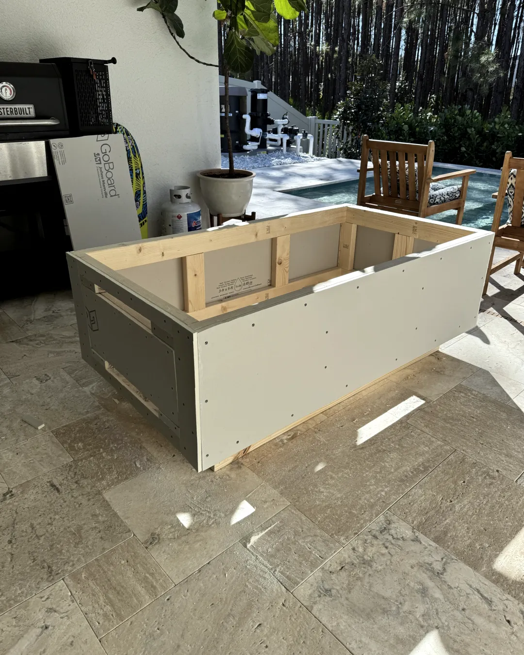 The frame covered in cement board, with the burner opening still empty